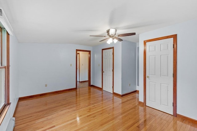 128 Arthur Ave, Athol, MA 01331 - unfurnished bedroom with baseboard heating, light wood-type flooring, baseboards, and a ceiling fan