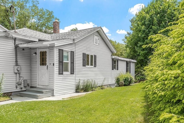128 Arthur Ave, Athol, MA 01331 - view of property exterior featuring roof with shingles, a lawn, and a chimney