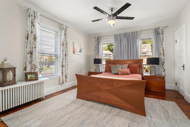110 Bigelow St, Boston, MA 02135 - bedroom with radiator heating unit, wood finished floors, baseboards, and ceiling fan