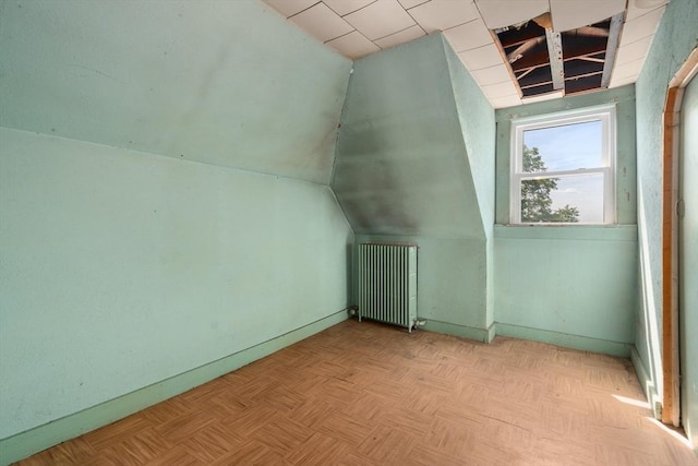 110 Bigelow St, Boston, MA 02135 - additional living space with radiator heating unit, baseboards, and lofted ceiling