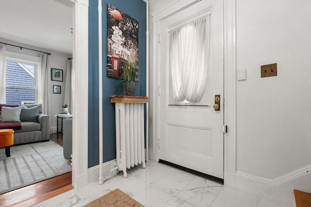 110 Bigelow St, Boston, MA 02135 - foyer entrance featuring marble look tiles, baseboards, and radiator heating unit