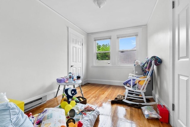 11 Barr St, Salem, MA 01970 - recreation room featuring a baseboard radiator, wood finished floors, and crown molding