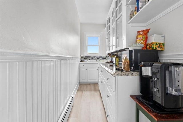 11 Barr St, Salem, MA 01970 - kitchen featuring white cabinets, wainscoting, glass insert cabinets, light wood-type flooring, and baseboard heating