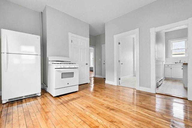 11 Barr St, Salem, MA 01970 - kitchen featuring white appliances, baseboard heating, light wood finished floors, and white cabinets