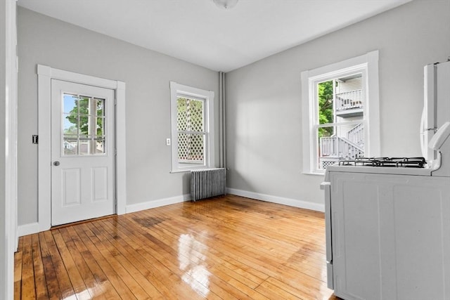 11 Barr St, Salem, MA 01970 - entryway with radiator heating unit and light wood finished floors