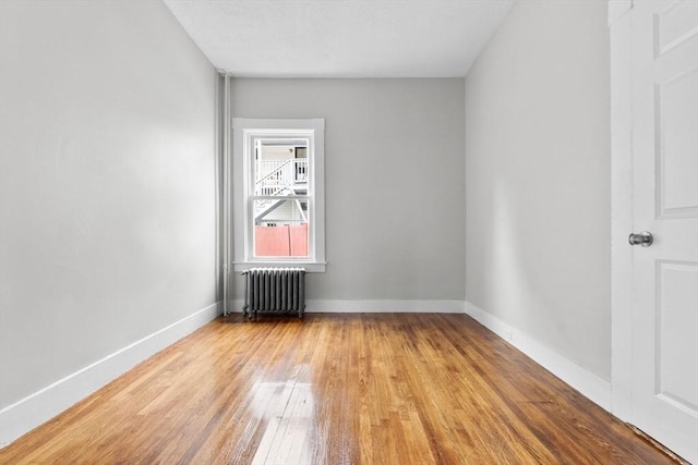 11 Barr St, Salem, MA 01970 - spare room featuring radiator heating unit and wood finished floors