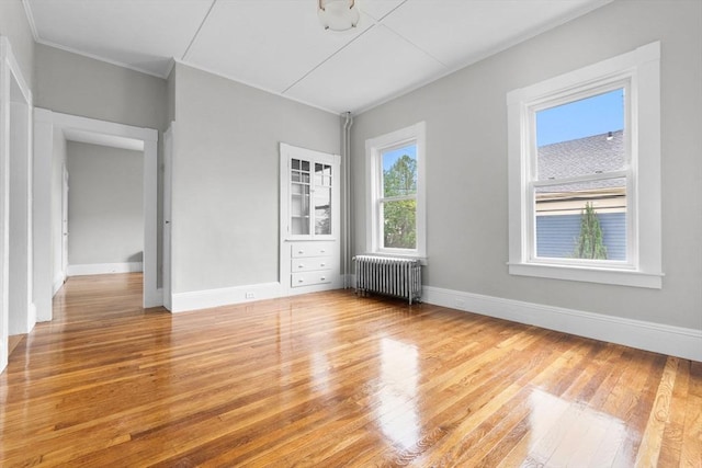 11 Barr St, Salem, MA 01970 - unfurnished bedroom featuring radiator, wood finished floors, and crown molding