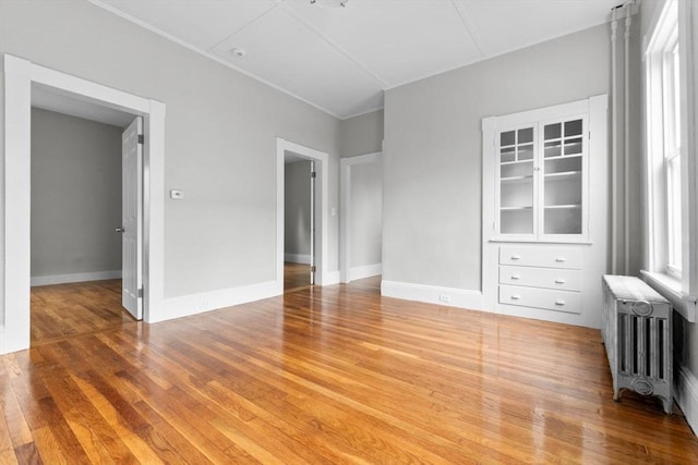 11 Barr St, Salem, MA 01970 - spare room featuring wood finished floors, radiator, and crown molding