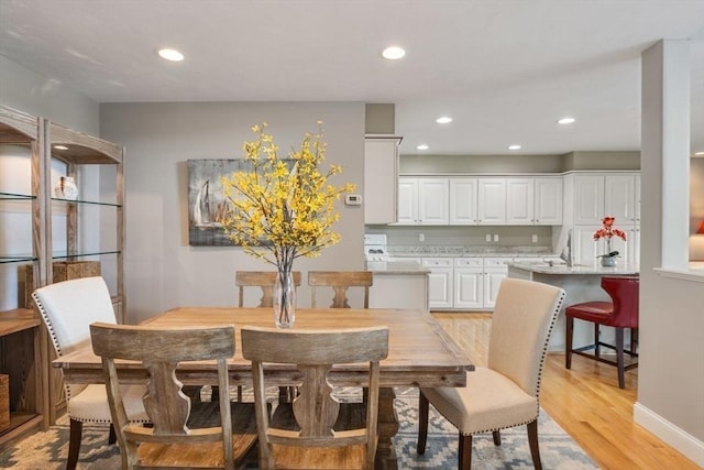 dining space with light wood-type flooring