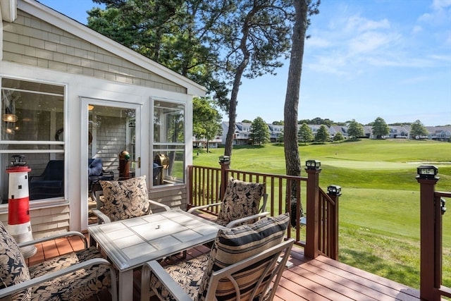 wooden deck featuring a lawn