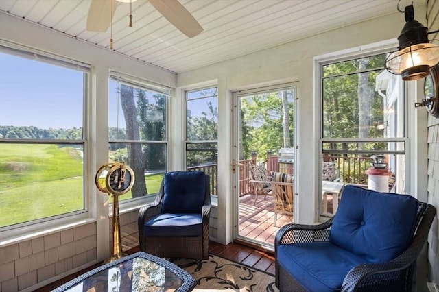 sunroom featuring ceiling fan