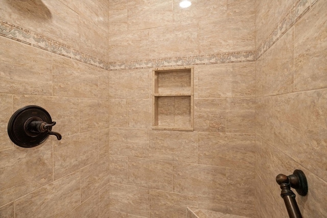 interior details with a tile shower