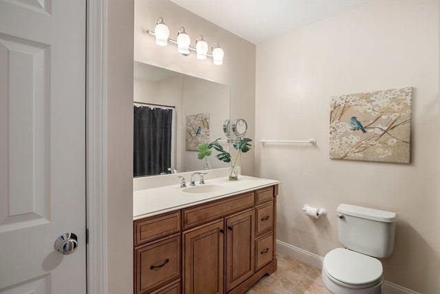 bathroom featuring vanity, toilet, and tile patterned flooring