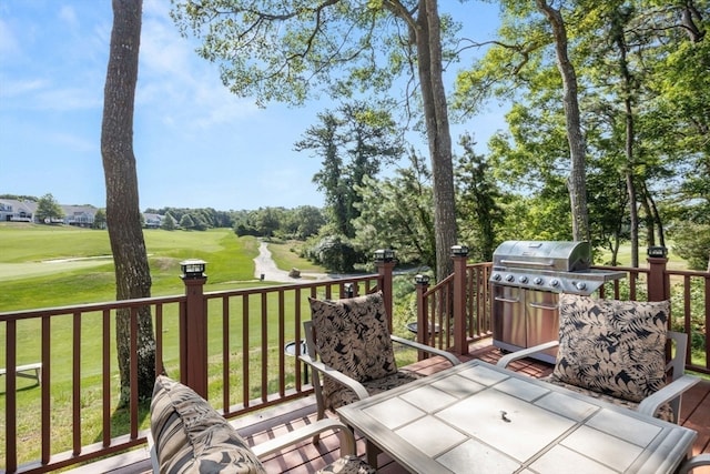 deck featuring a yard and area for grilling