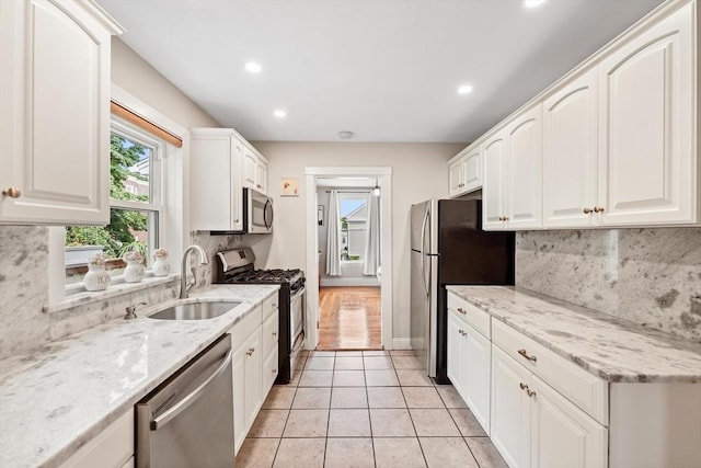 21 Minot St Unit 2A, Boston, MA 02122 - kitchen featuring stainless steel appliances, a sink, white cabinetry, backsplash, and recessed lighting