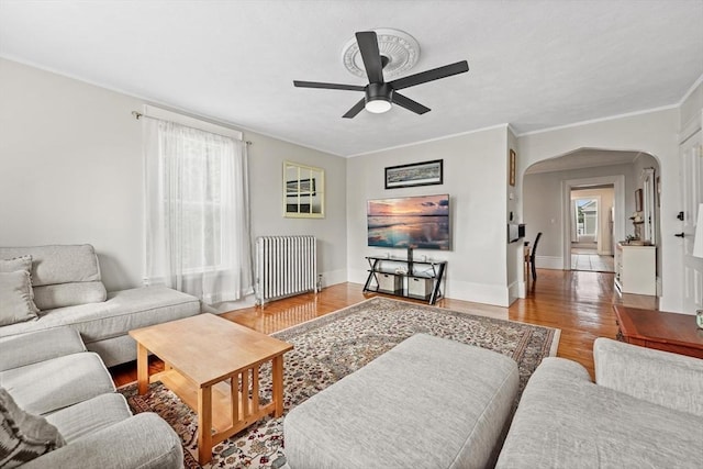 21 Minot St Unit 2A, Boston, MA 02122 - living area with radiator, arched walkways, a ceiling fan, wood finished floors, and ornamental molding