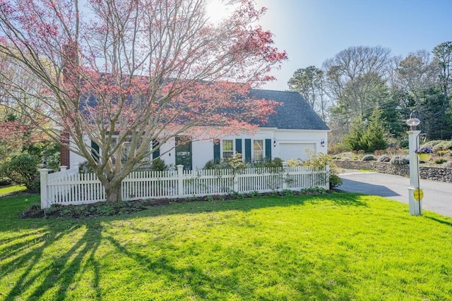 obstructed view of property featuring driveway and a garage