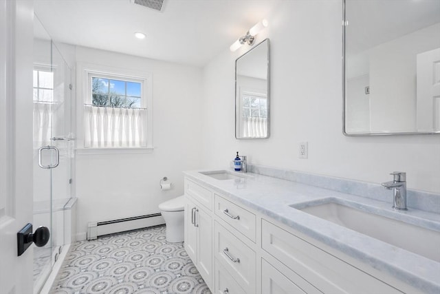 bathroom with a baseboard radiator, plenty of natural light, toilet, a stall shower, and recessed lighting