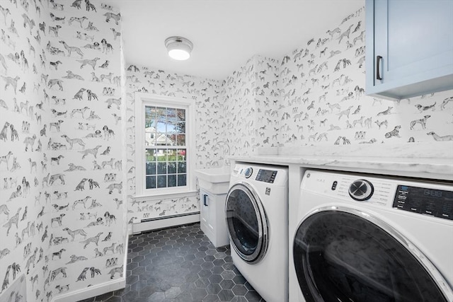 washroom featuring washing machine and dryer, wallpapered walls, cabinet space, a baseboard heating unit, and baseboards