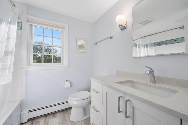 full bath featuring a baseboard radiator, toilet, vanity, and shower / tub combo