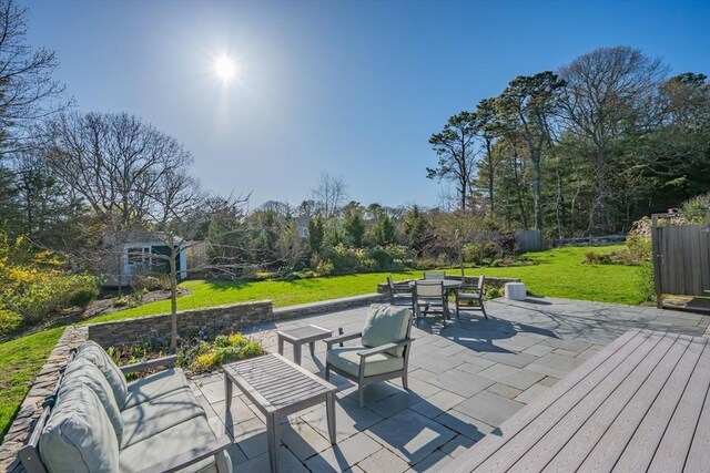 view of patio with outdoor dining area and a wooden deck