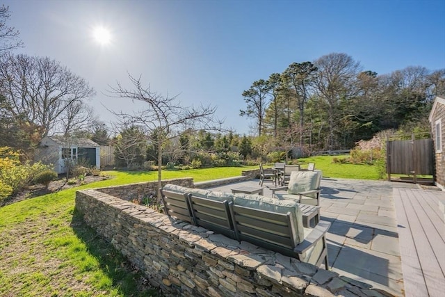 view of patio / terrace featuring an outdoor living space and an outbuilding