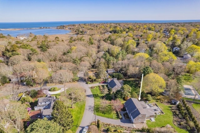 drone / aerial view of a large body of water and a heavily wooded area