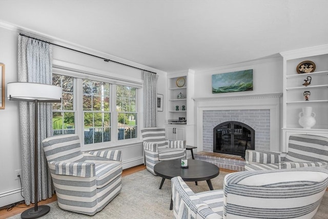 living room with wood finished floors, a fireplace, crown molding, baseboard heating, and built in features