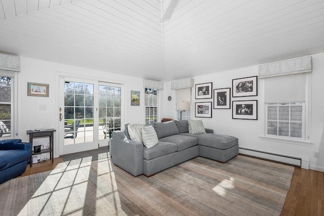 living room with baseboard heating, plenty of natural light, and wood finished floors