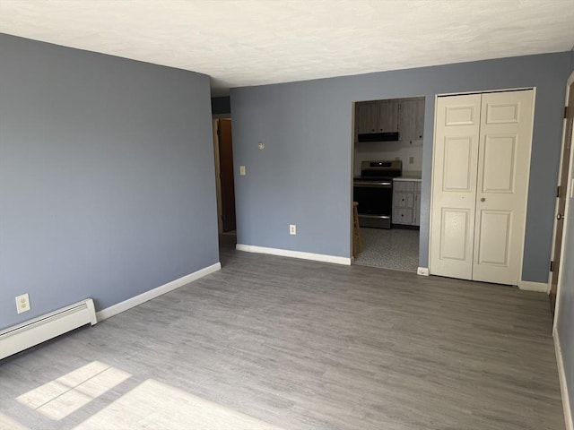 924 Main St Unit 26, Woburn, MA 01801 - unfurnished room featuring baseboard heating and wood finished floors