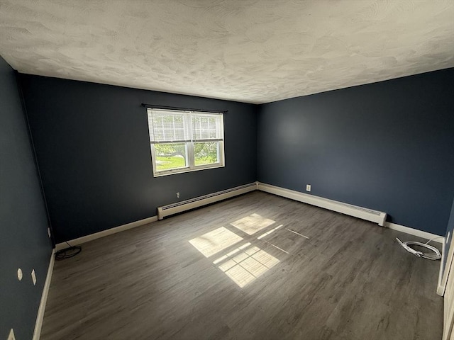 924 Main St Unit 26, Woburn, MA 01801 - spare room featuring a textured ceiling, a baseboard heating unit, and wood finished floors
