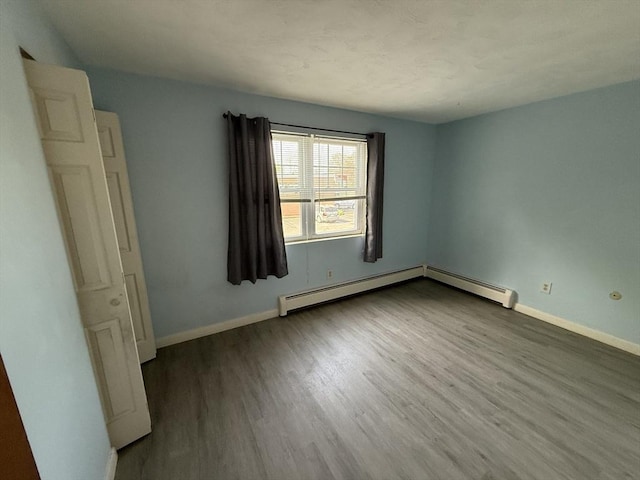 924 Main St Unit 26, Woburn, MA 01801 - unfurnished room featuring wood finished floors and baseboard heating