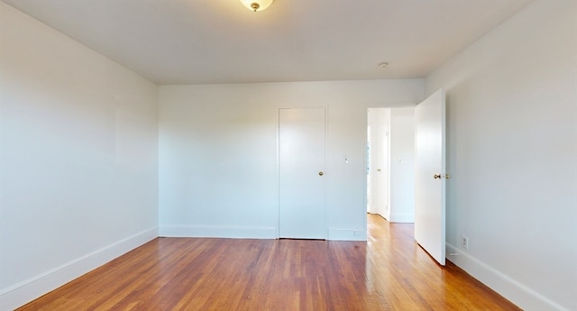 unfurnished room with hardwood / wood-style floors