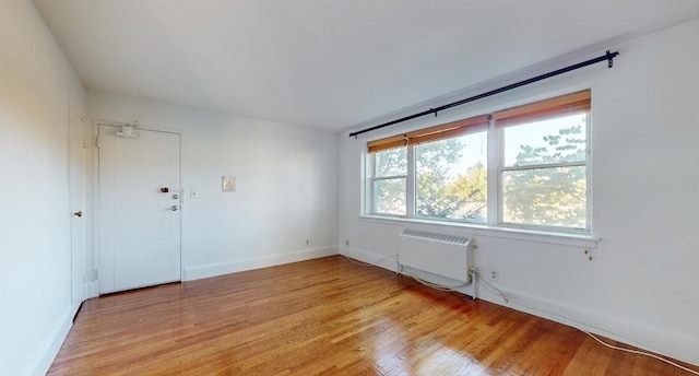 461 Arborway Unit 2, Boston, MA 02130 - empty room featuring light wood-style flooring, baseboards, and radiator