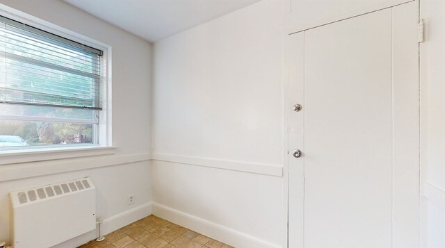 spare room featuring radiator