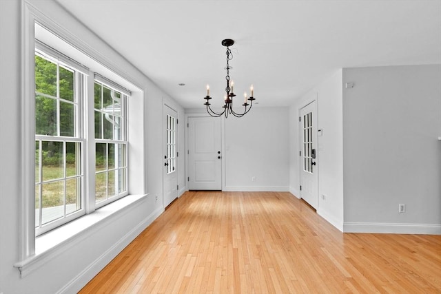 258 Plympton Rd, Plymouth, MA 02360 - unfurnished dining area with a chandelier, healthy amount of natural light, and baseboards