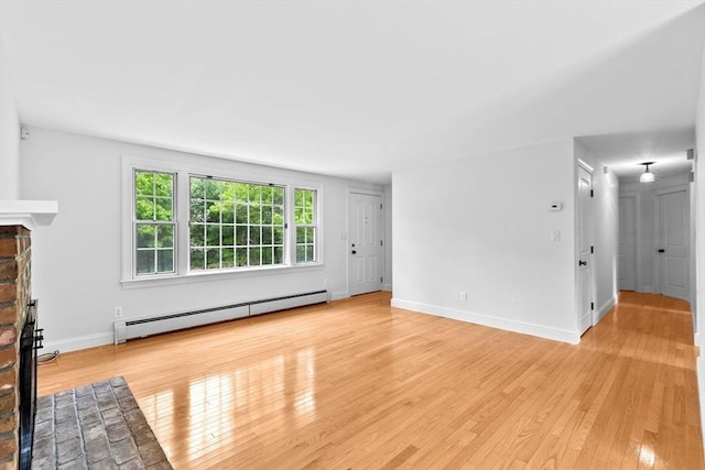 258 Plympton Rd, Plymouth, MA 02360 - unfurnished living room featuring a baseboard heating unit, a fireplace, light wood finished floors, and baseboards