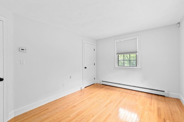 258 Plympton Rd, Plymouth, MA 02360 - spare room featuring a baseboard radiator, wood finished floors, and baseboards