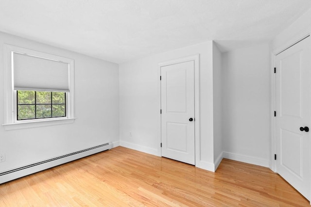 258 Plympton Rd, Plymouth, MA 02360 - unfurnished bedroom with baseboard heating, light wood-style flooring, and baseboards