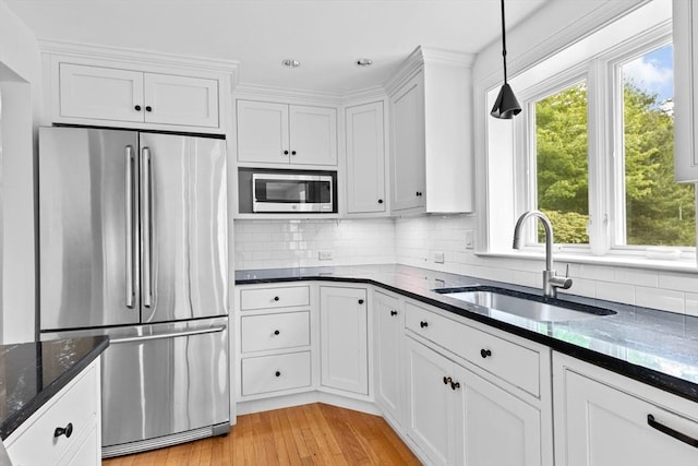 258 Plympton Rd, Plymouth, MA 02360 - kitchen with stainless steel appliances, a sink, white cabinetry, plenty of natural light, and recessed lighting