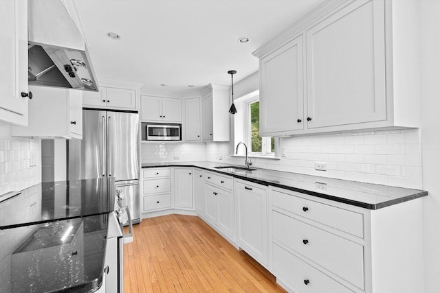 258 Plympton Rd, Plymouth, MA 02360 - kitchen featuring a sink, wall chimney exhaust hood, stainless steel appliances, dark stone counters, and white cabinets