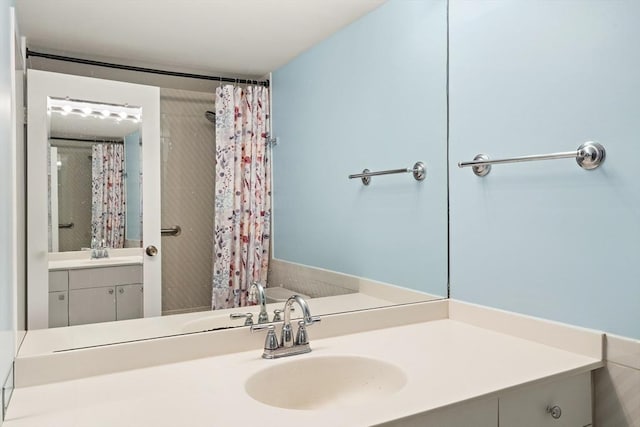 bathroom featuring vanity and a shower with shower curtain