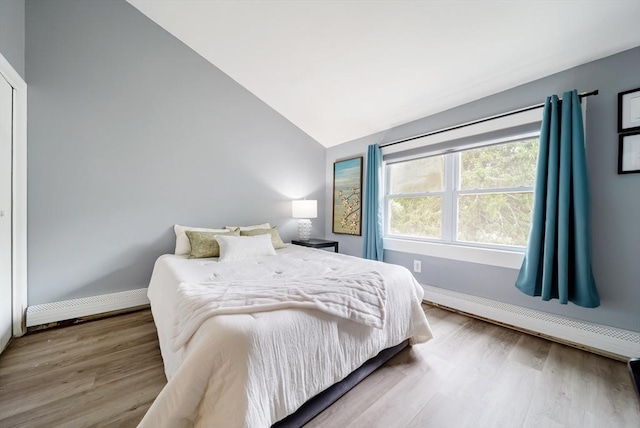 27 Mason Ct Unit 27, Amesbury, MA 01913 - bedroom featuring lofted ceiling, wood finished floors, baseboards, and a baseboard radiator