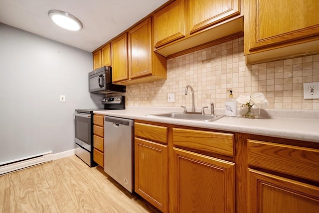 27 Mason Ct Unit 27, Amesbury, MA 01913 - kitchen with appliances with stainless steel finishes, a sink, tasteful backsplash, and brown cabinetry