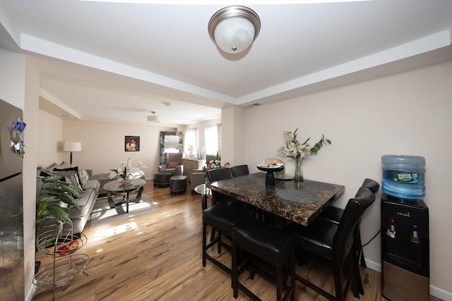 dining room with light wood-style flooring and baseboards