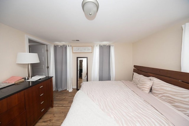 bedroom featuring visible vents and light wood-style flooring