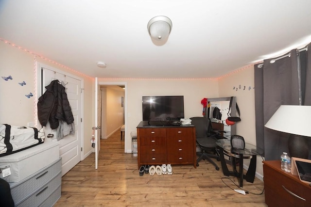 bedroom with baseboards and light wood-style floors