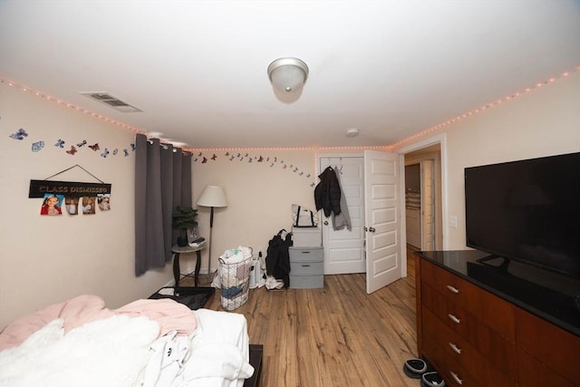 bedroom featuring light wood-type flooring and visible vents