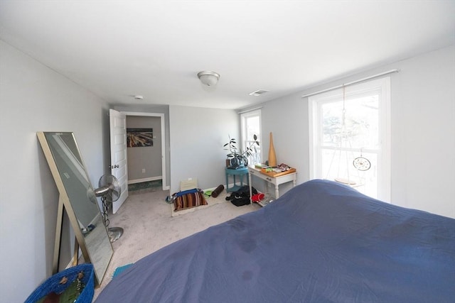 carpeted bedroom featuring visible vents and baseboards