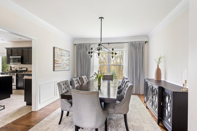 86 Pioneer Trl, Plymouth, MA 02360 - dining space featuring a chandelier, crown molding, light wood-style flooring, and a wainscoted wall